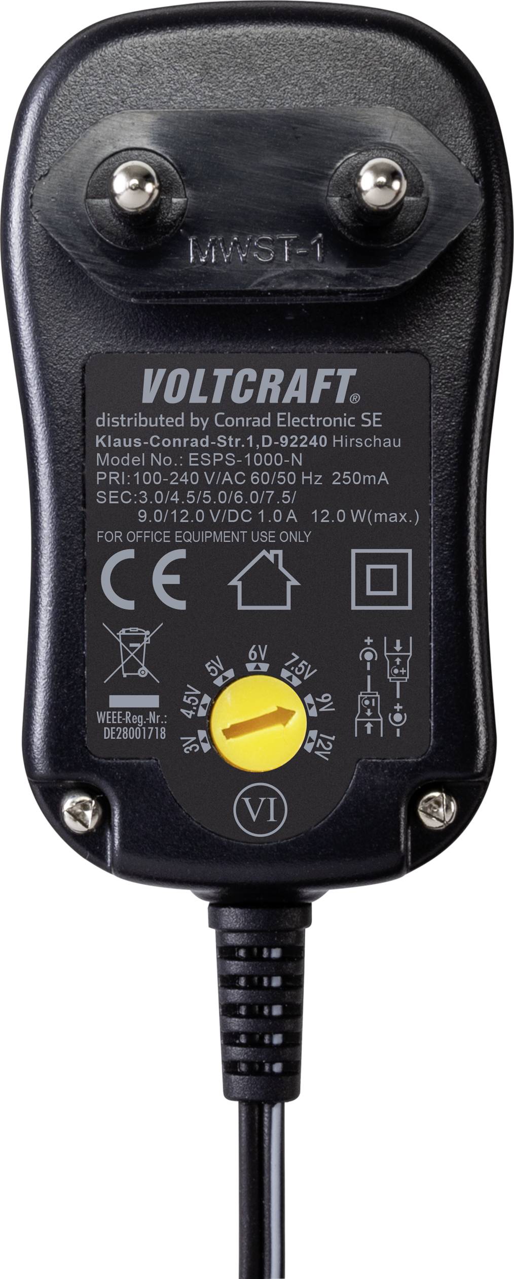 Schwarzes Netzteil mit zwei Eurosteckern, Label zeigt 'VOLTCRAFT', technische Details und Spannungswahlschalter von 3 bis 12 Volt.