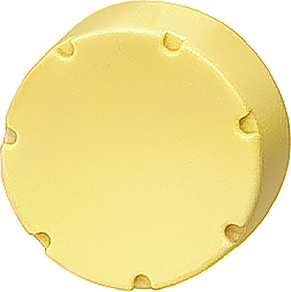 Rundes, gelbes Objekt, möglicherweise ein Kunststoffdeckel mit symmetrisch angeordneten Einkerbungen am Rand.