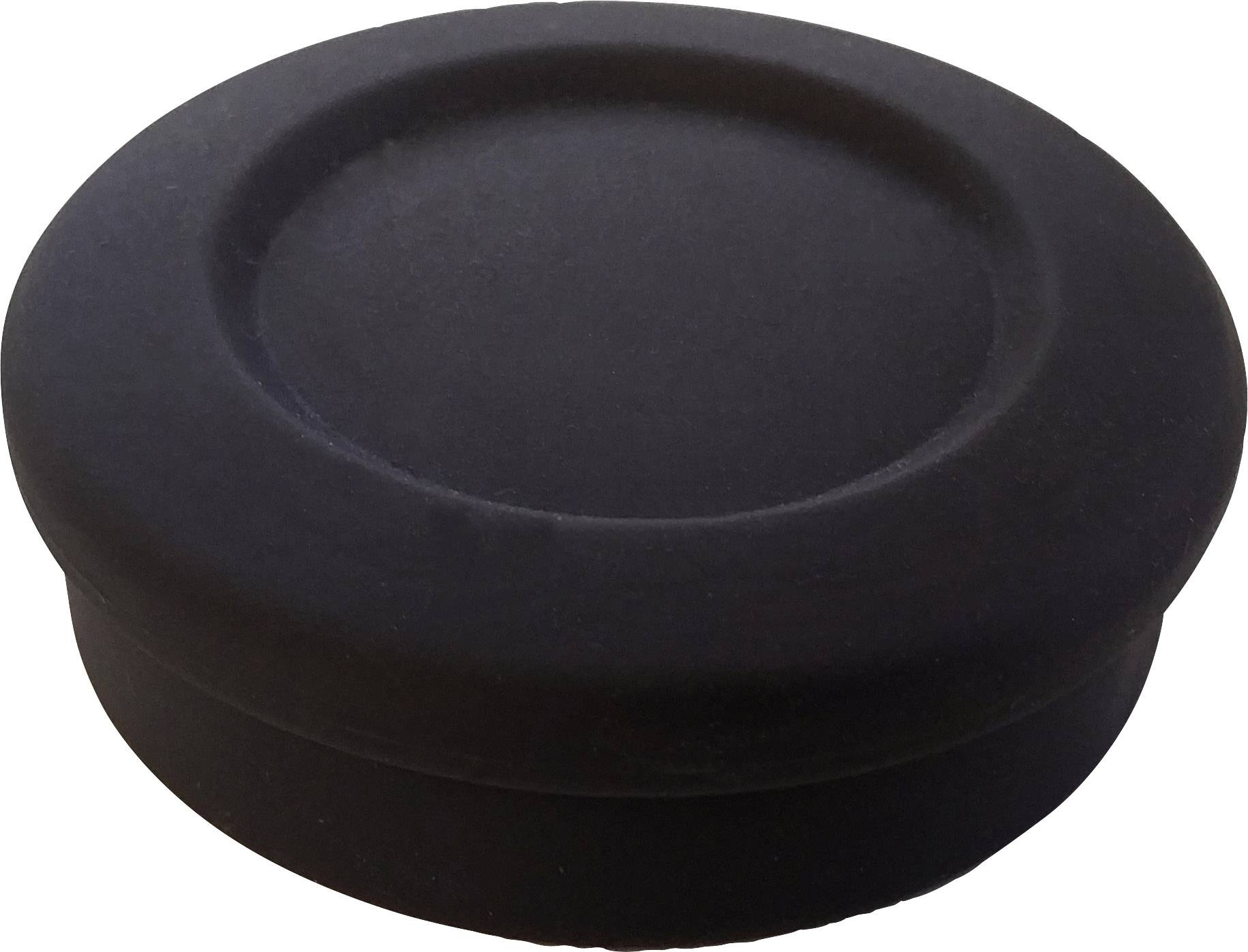 Ein einzelner schwarzer Puck, auf einer weißen Fläche fotografiert.