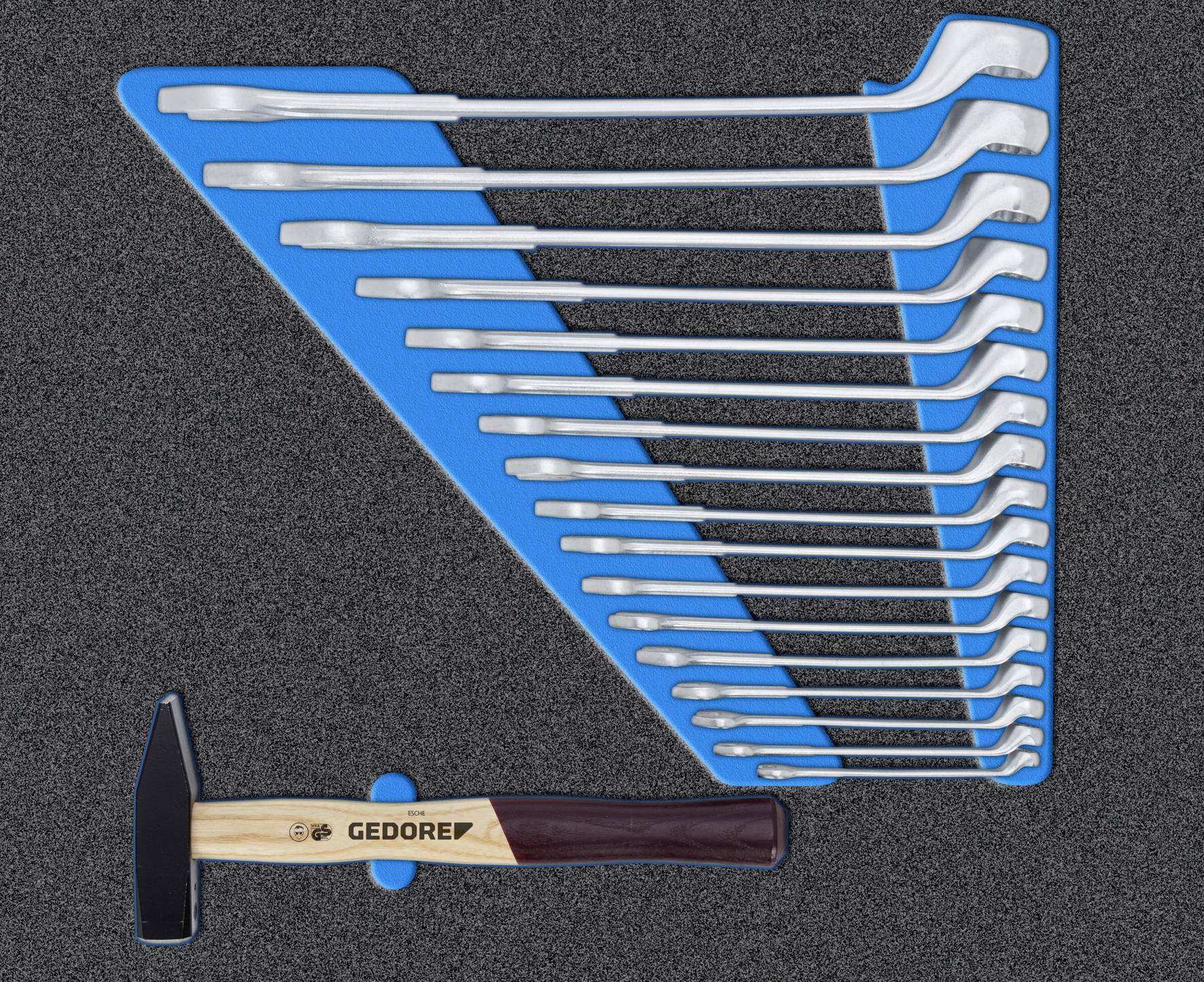 Werkzeugsatz mit Hammer und L-förmigen Schraubenschlüsseln in verschiedenen Größen auf einem geformten blauen Einsatz.