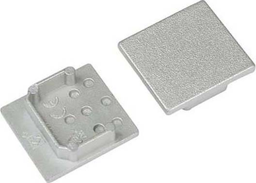 Zwei silberne Metallplatten, eine mit erhabenen Punkten und Markierungen, wahrscheinlich als Teil eines Stecksystems.