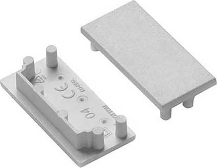 Zwei rechteckige Kunststoffabdeckungen mit hervorstehenden Stiften zur Befestigung, eine zeigt Symbole und Spezifikationen.