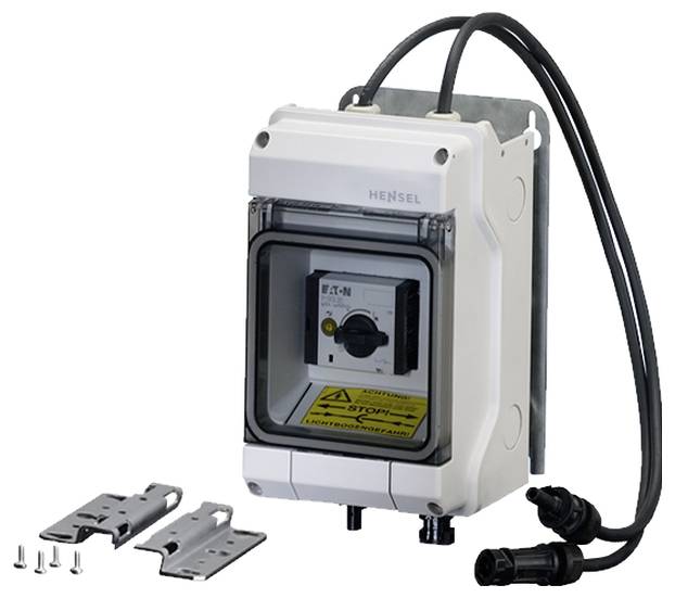 Ein elektrischer Schaltschrank mit Beschriftung 'EATON'. Enthält einen Schalter, Kabelanschlüsse, Montagematerial und Schutzgehäuse.