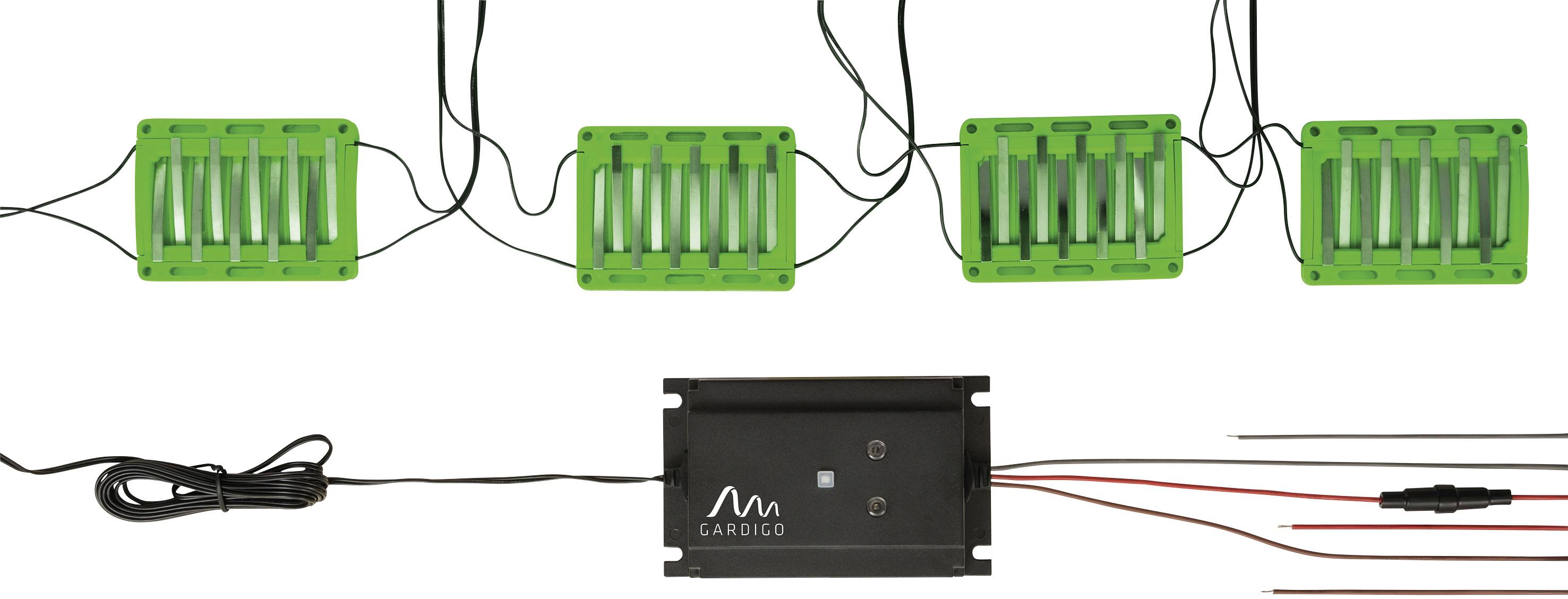 Vier grüne Sensorplatten sind mit einem schwarzen Gerät verbunden. Kabel verlaufen zwischen diesen Komponenten.