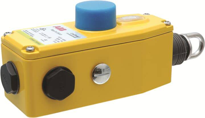 Gelbes Industrieschaltergehäuse mit blauem Druckknopf und Schraubanschlüssen.