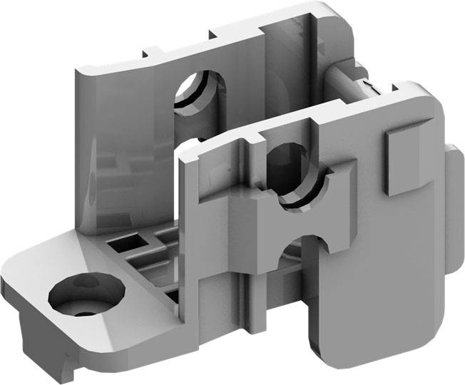 Ein graues mechanisches Bauteil mit mehreren Aussparungen und Öffnungen, möglicherweise Teil einer größeren Maschine oder Vorrichtung.