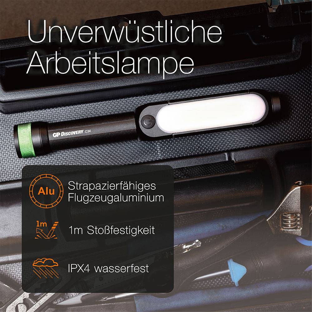 Arbeitslampe liegt auf Werkzeugkoffer. Text: 'Unverwüstliche Arbeitslampe', 'Alu', 'Strapazierfähiges Flugzeugaluminium', '1m Stoßfestigkeit', 'IPX4 wasserfest'.