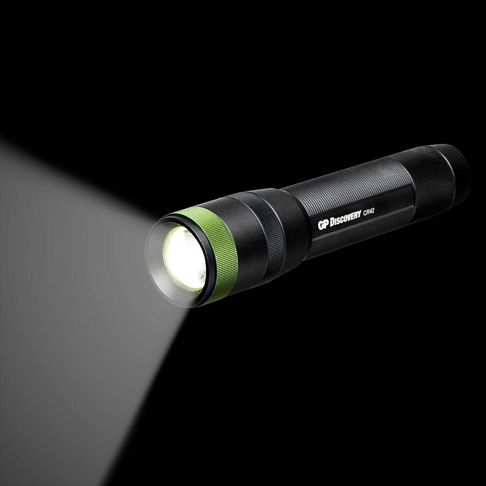 Schwarze Taschenlampe leuchtet nach links. Dicker Griff, silber-grüne Frontkappe.