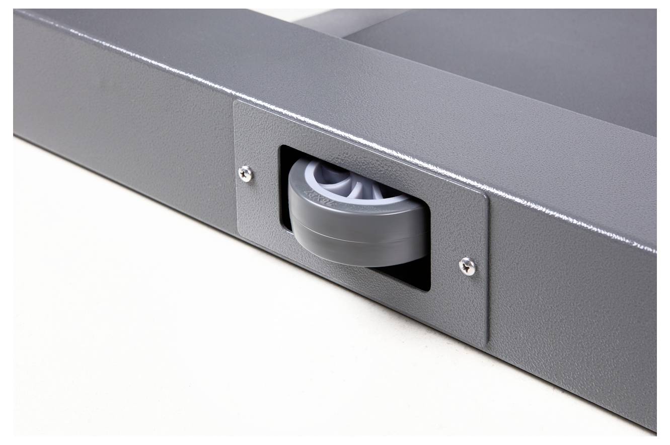 Eine graue Rolle ist in ein rechteckiges Metallgehäuse eingebaut. Die Rolle ist teilweise sichtbar und dient zur Unterstützung beim Bewegen.