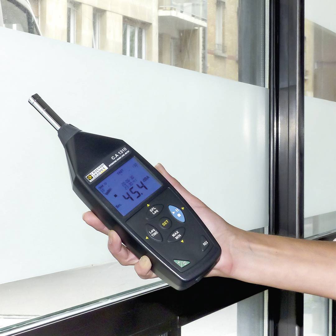 Eine Person hält ein digitales Messgerät an eine Glasscheibe. Das Display zeigt die Temperatur von -4,5 Grad Celsius an.