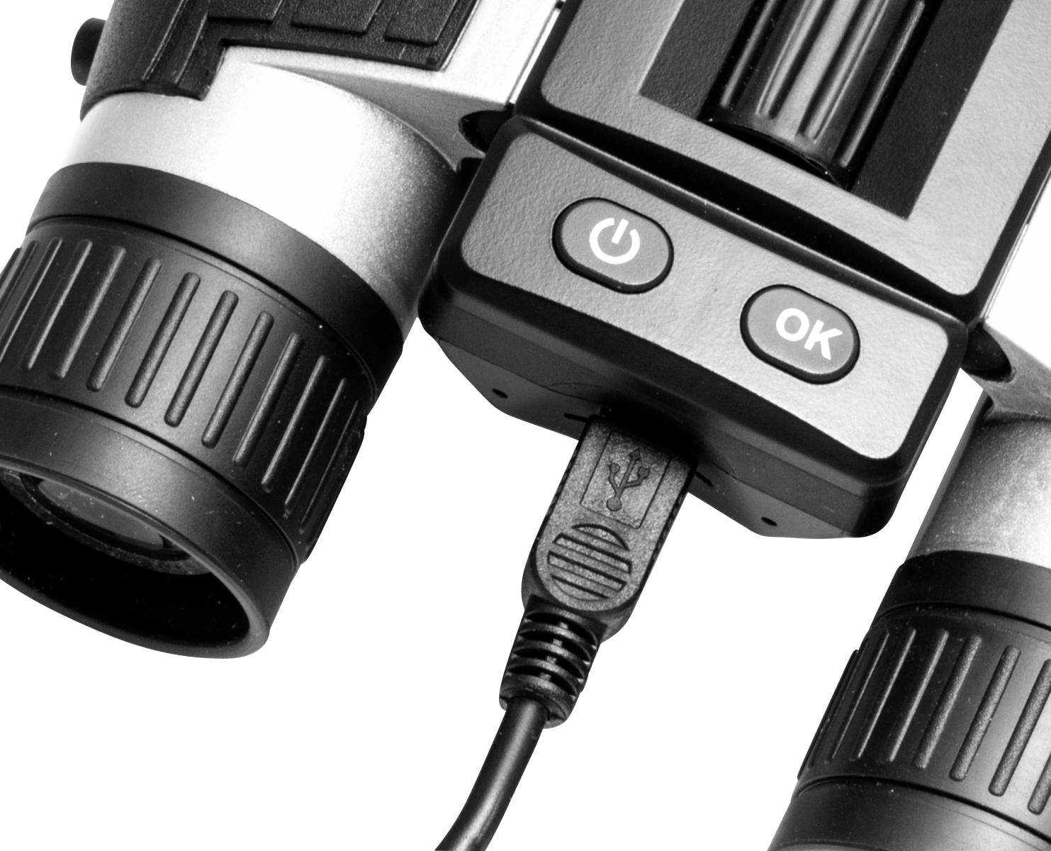 Nahaufnahme eines elektronischen Geräts mit USB-Anschluss, zwei Objektiven und Bedienknöpfen mit den Symbolen 'Power' und 'OK'.