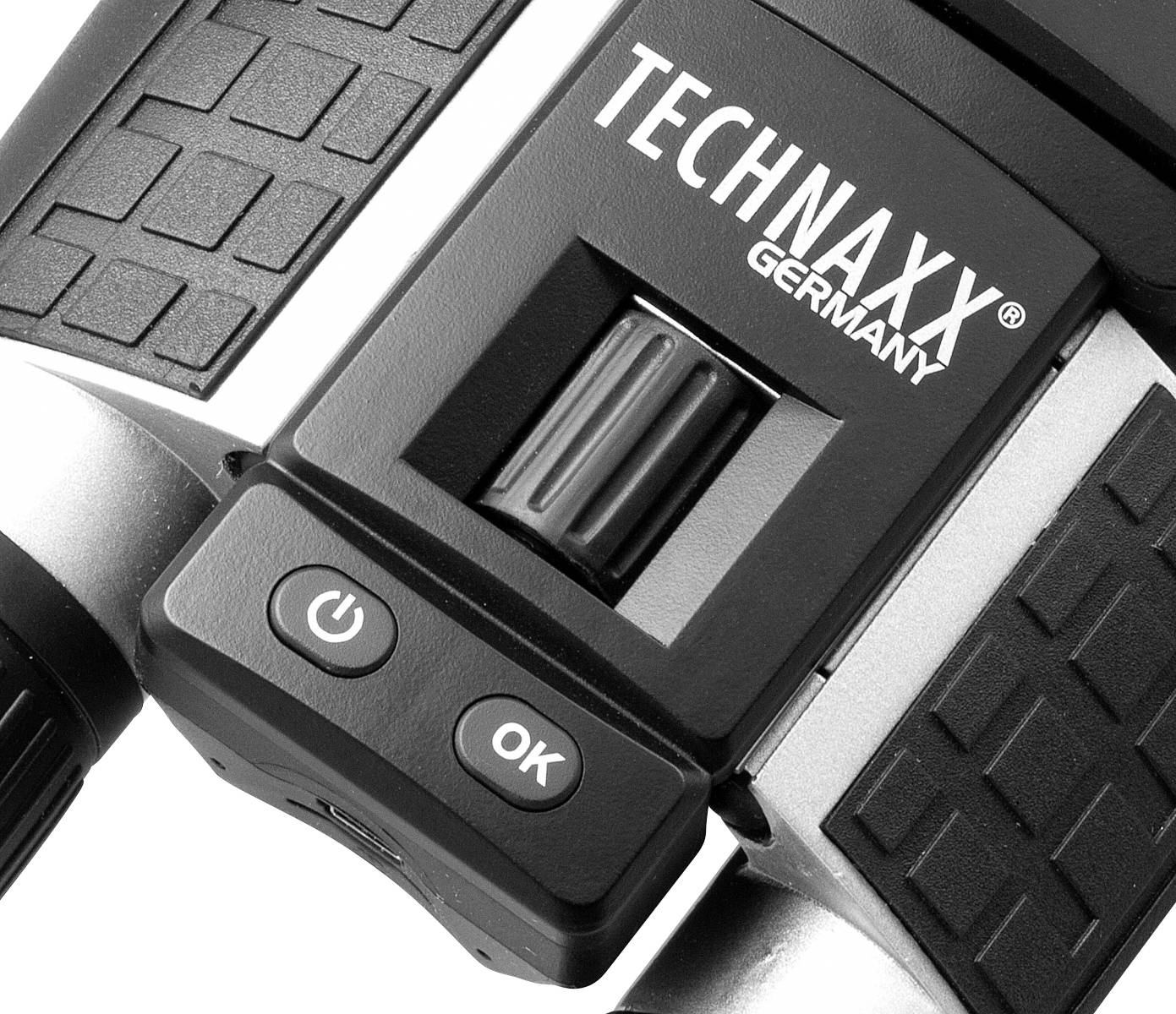 Nahaufnahme eines Teils eines elektronischen Geräts mit der Beschriftung 'TECHNAXX GERMANY', einem Rad und zwei Tasten: 'Power' und 'OK'.