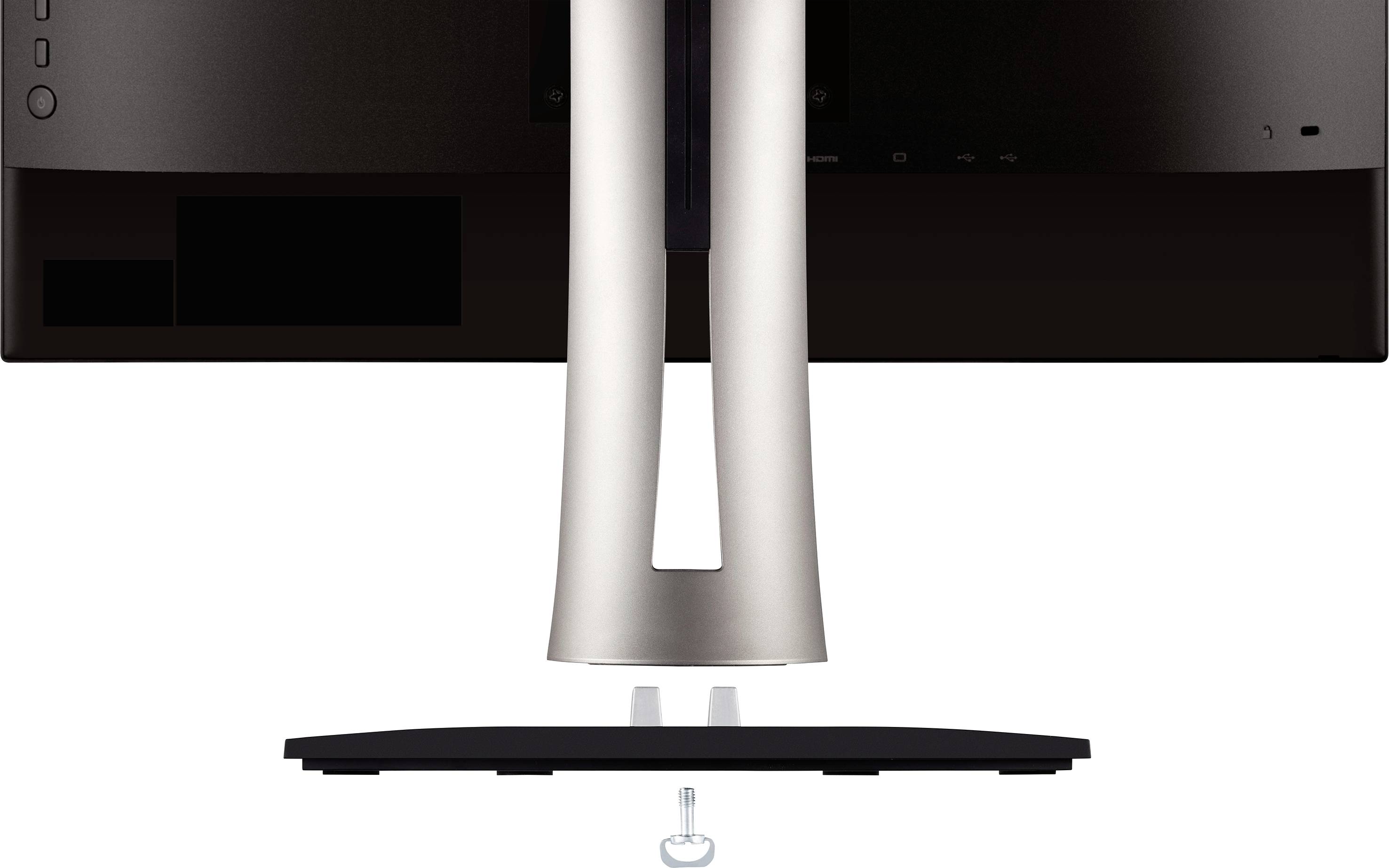 Ein Computerbildschirm wird von hinten gezeigt, auf einem Standfuß montiert. Eine Schraube liegt darunter, um die Stabilität zu gewährleisten.