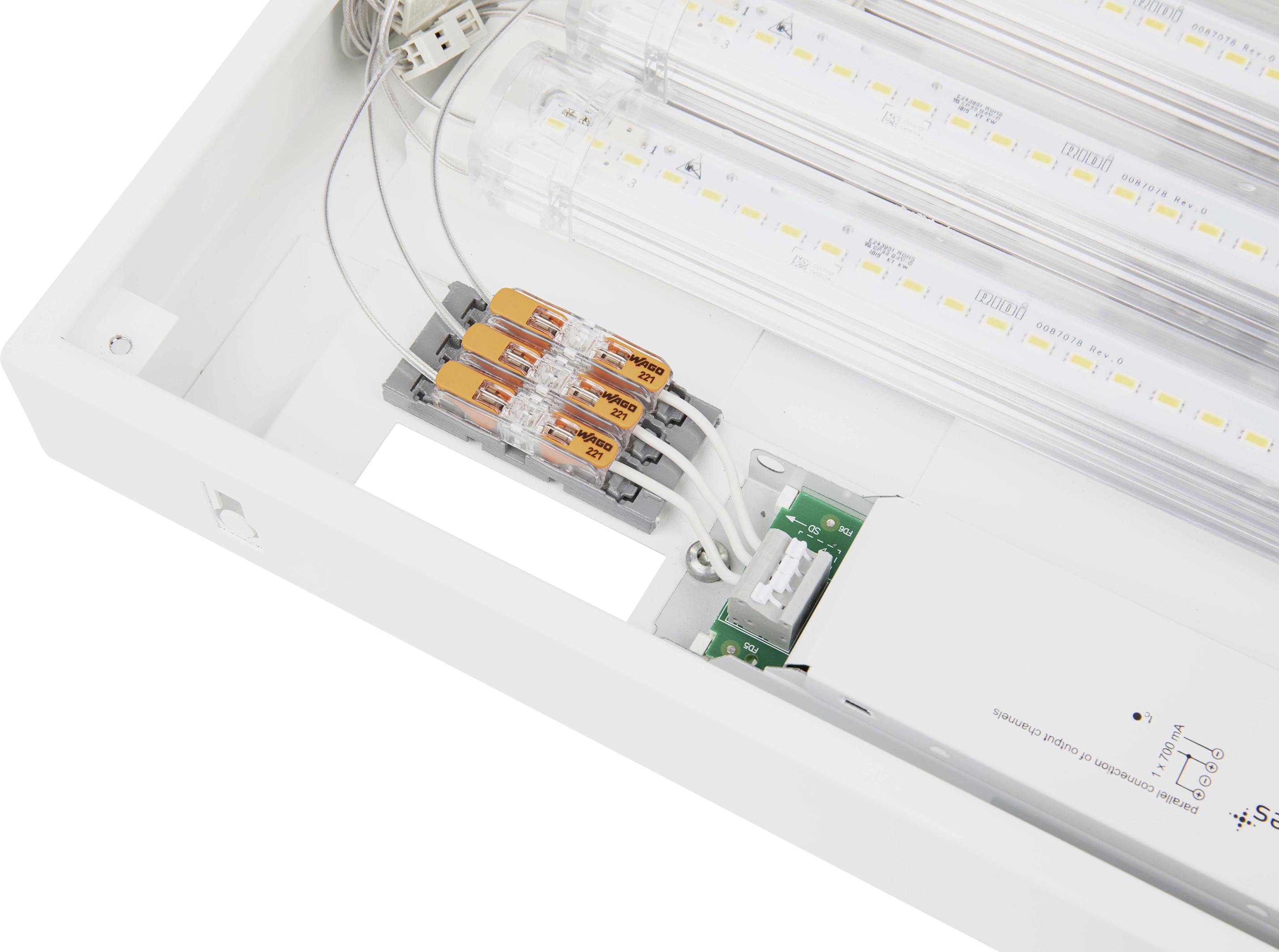 LED-Leuchte mit transparentem Gehäuse, zeigt interne elektrische Verdrahtung und Komponenten, einschließlich eines weißen Konverters und Anschlussklemmen.