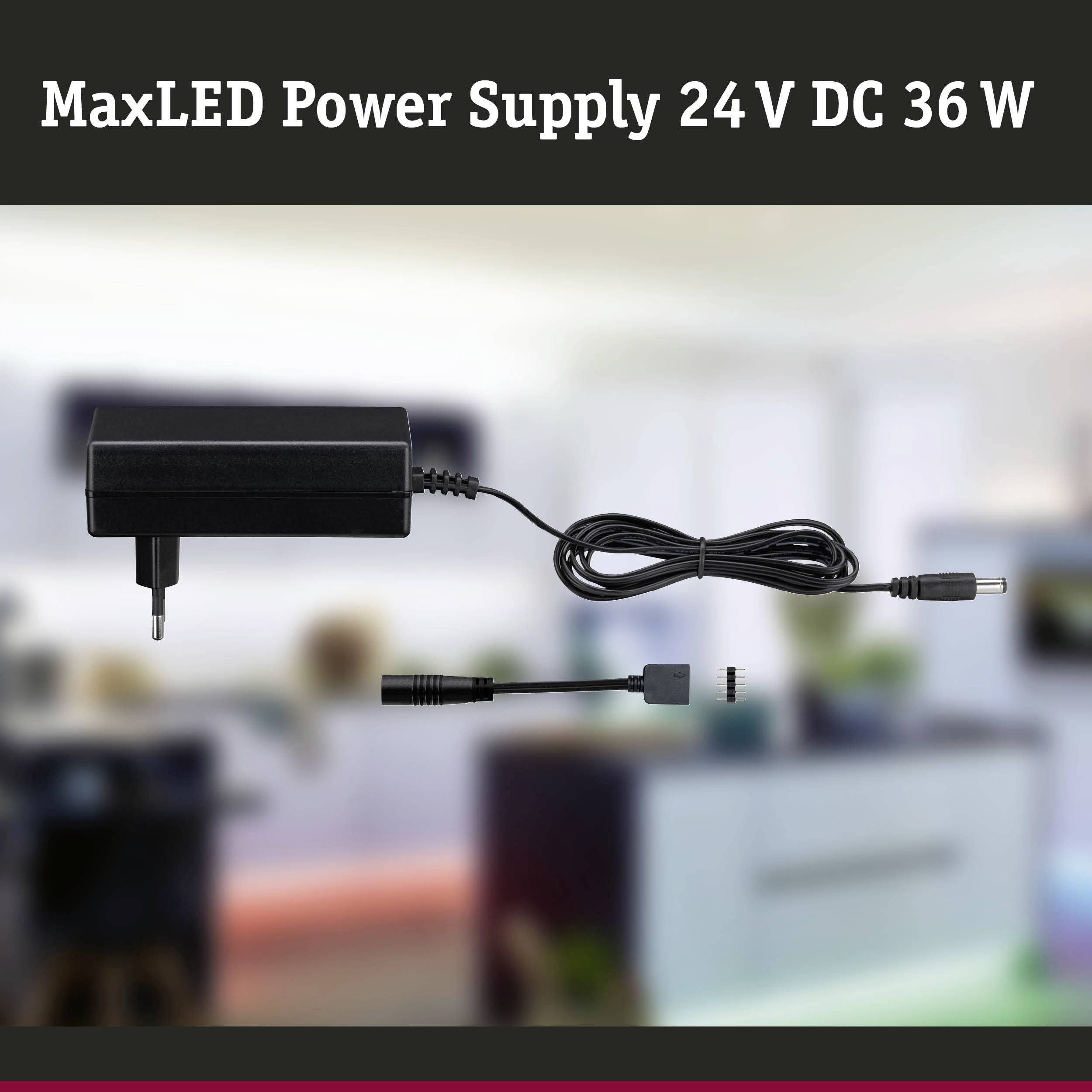 MaxLED Stromversorgung, 24 V DC, 36 W Ladegerät und Kabel im Fokus, unscharfer Hintergrund mit Möbeln und Fenstern.