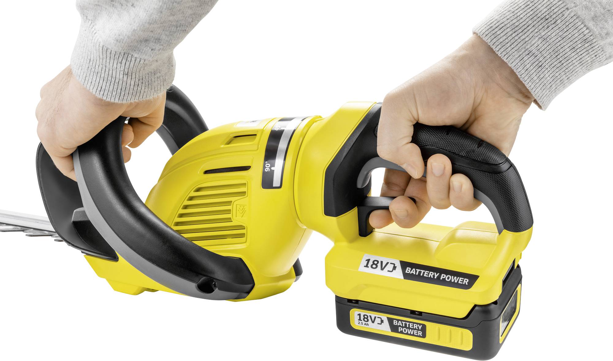 Zwei Hände halten eine gelbe Akku-Heckenschere. Auf der Batterie steht '18V Battery Power'.