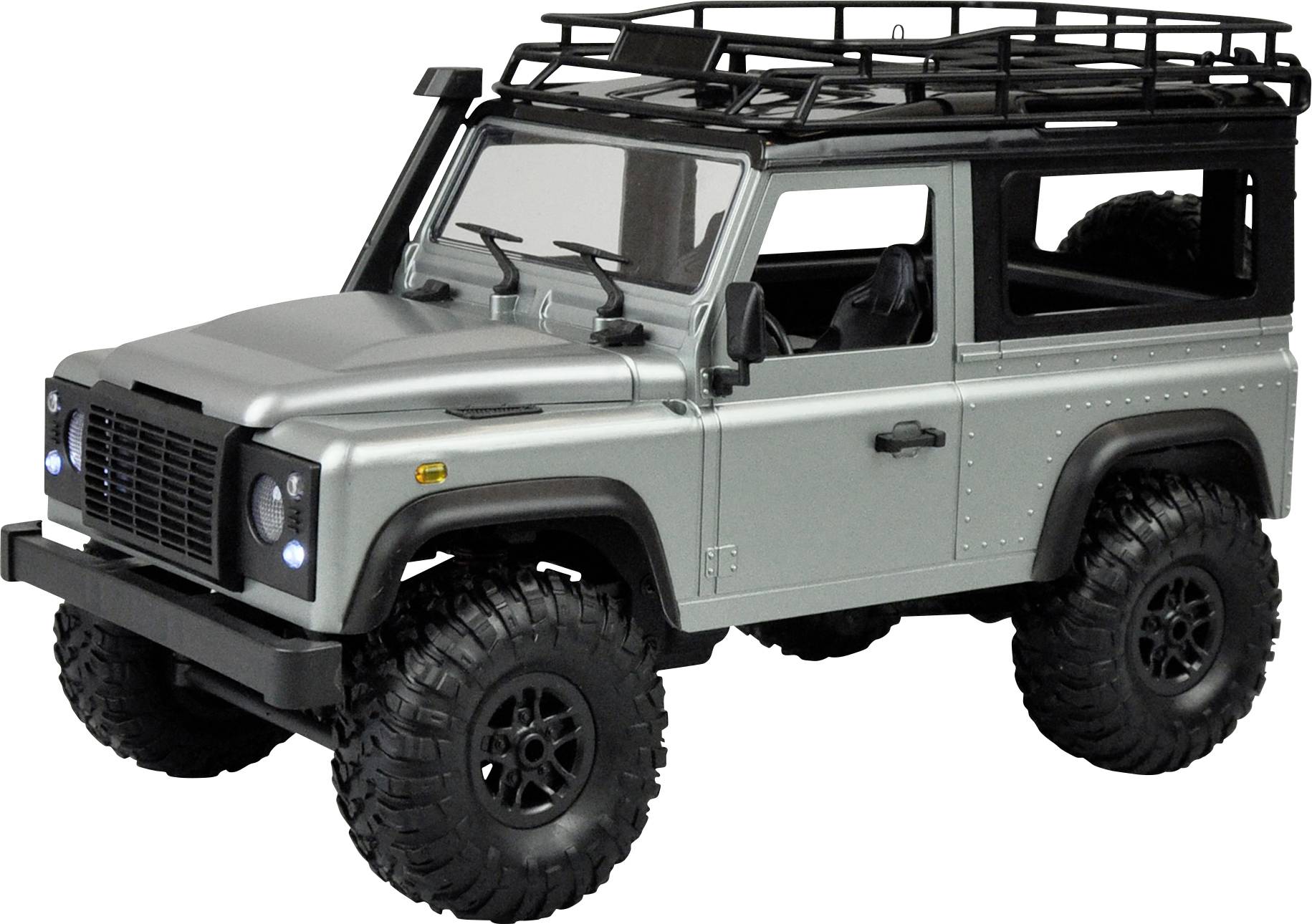 Ein silbernes Geländewagen-Modell mit Dachgepäckträger auf großen, grobstolligen Reifen. Sichtbar sind Frontlichter und Seitenansicht.