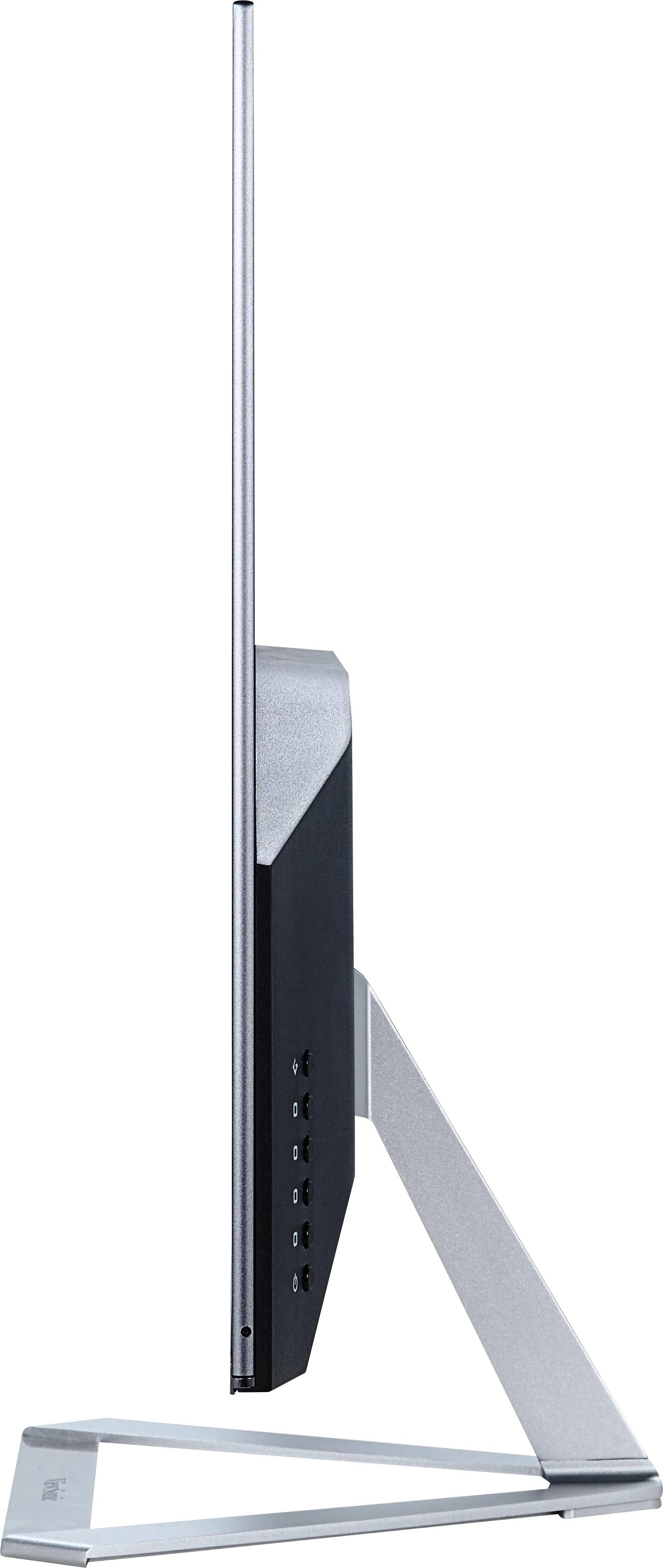 Ein ultradünner Computerbildschirm von der Seite, montiert auf einem schlanken Metallständer, mit mehreren Anschlüssen sichtbar.