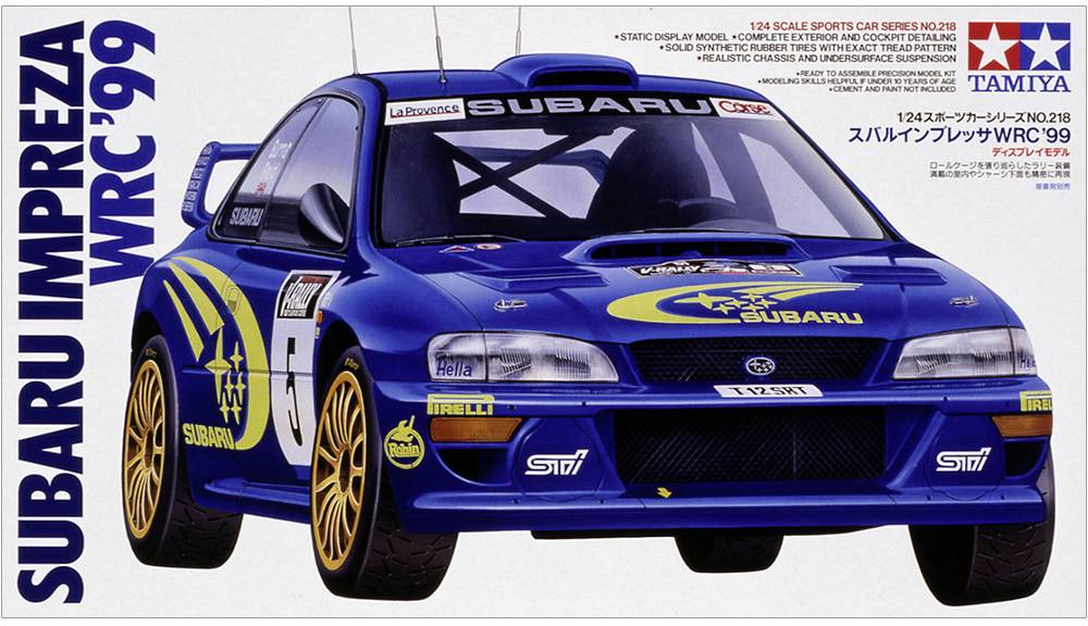 'Modellauto Subaru Impreza WRC '99 von Tamiya in Blau mit gelben Details, abgebildet auf einer Kartonverpackung.'
