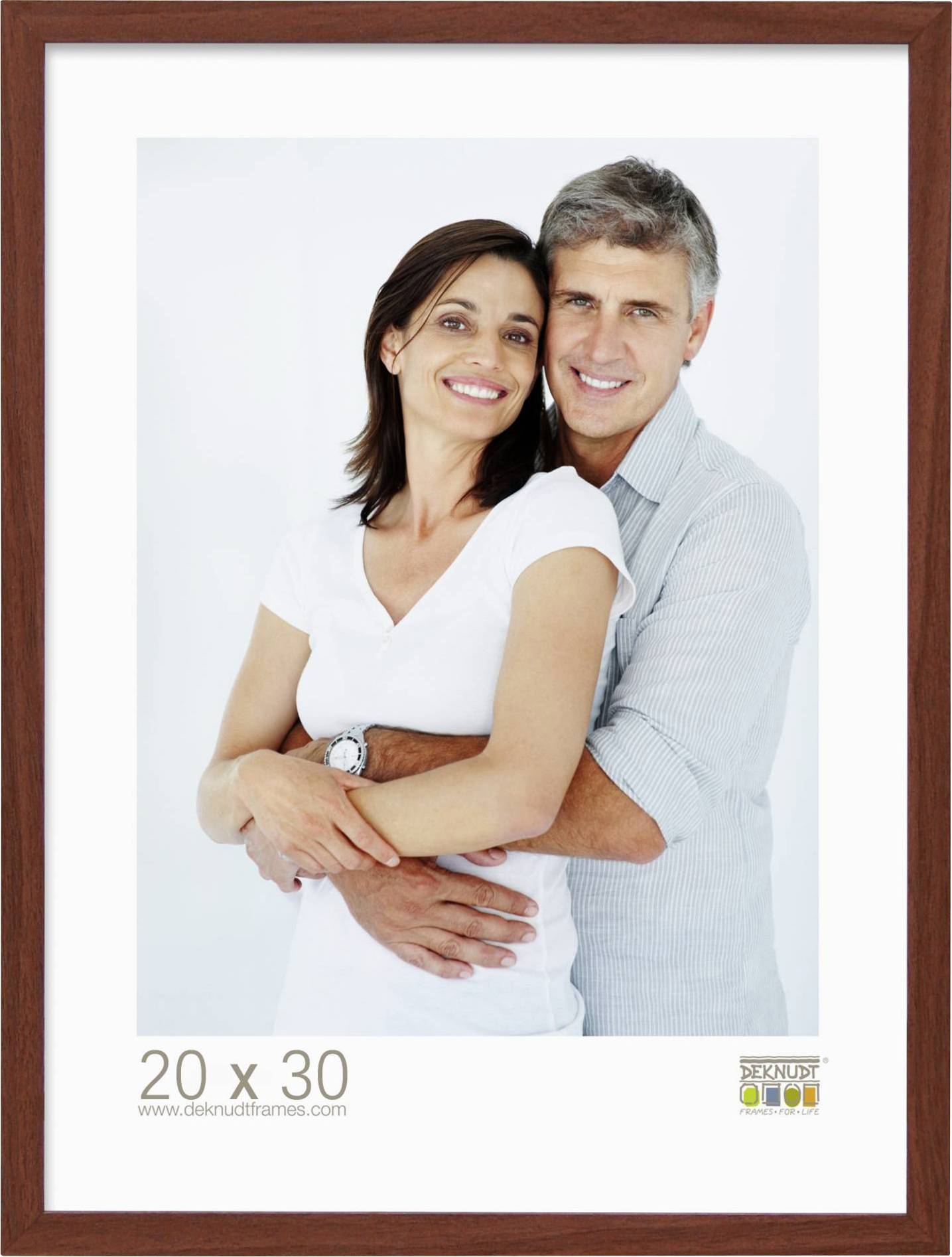 Ein lächelndes Paar posiert umarmt vor einem weißen Hintergrund. Beide tragen lässige Kleidung. Am unteren Rand steht: '20 x 30'.