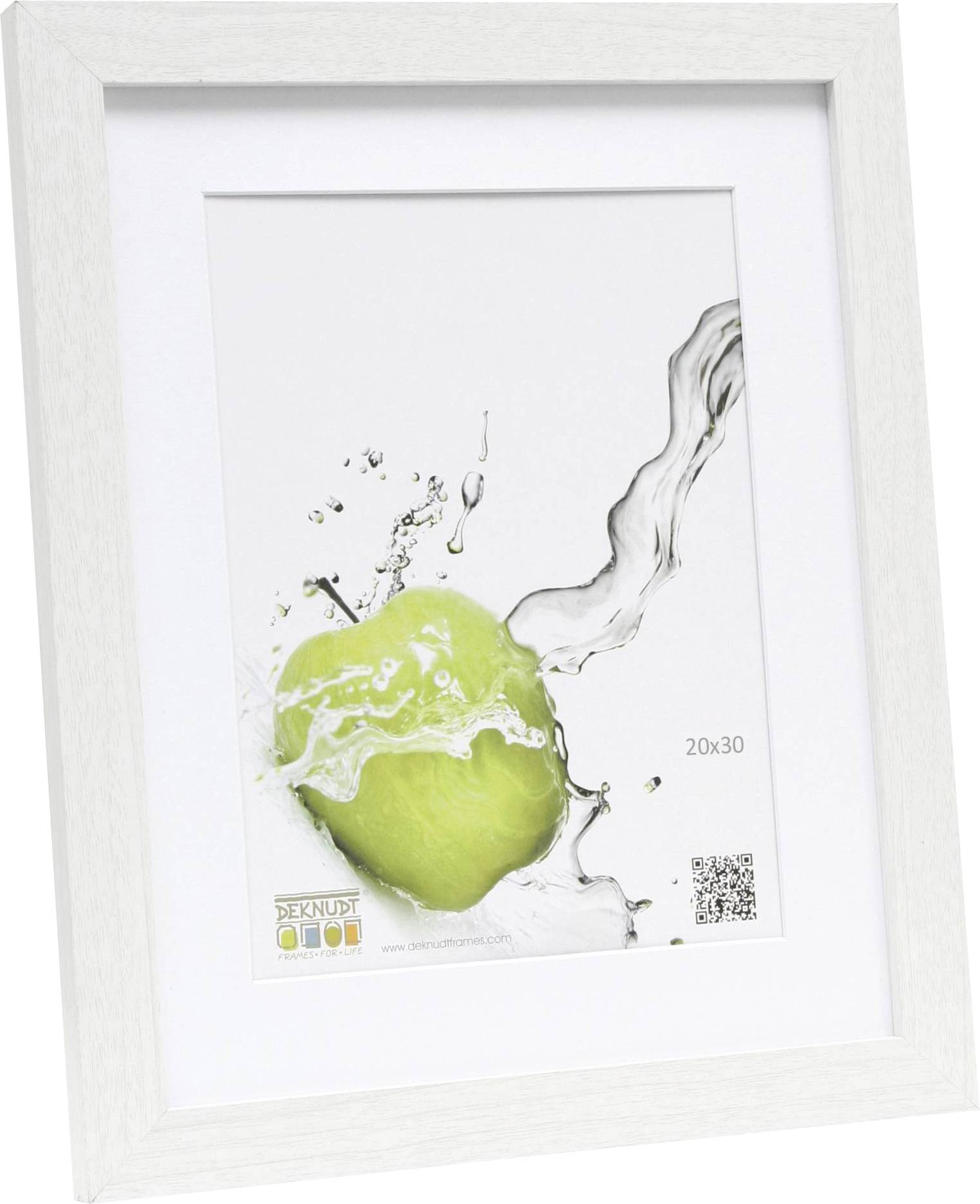 Ein weißer Bilderrahmen zeigt ein Bild mit einem grünen Apfel, der von einer Wasserspritzer getroffen wird. Größe: 20x30 cm.