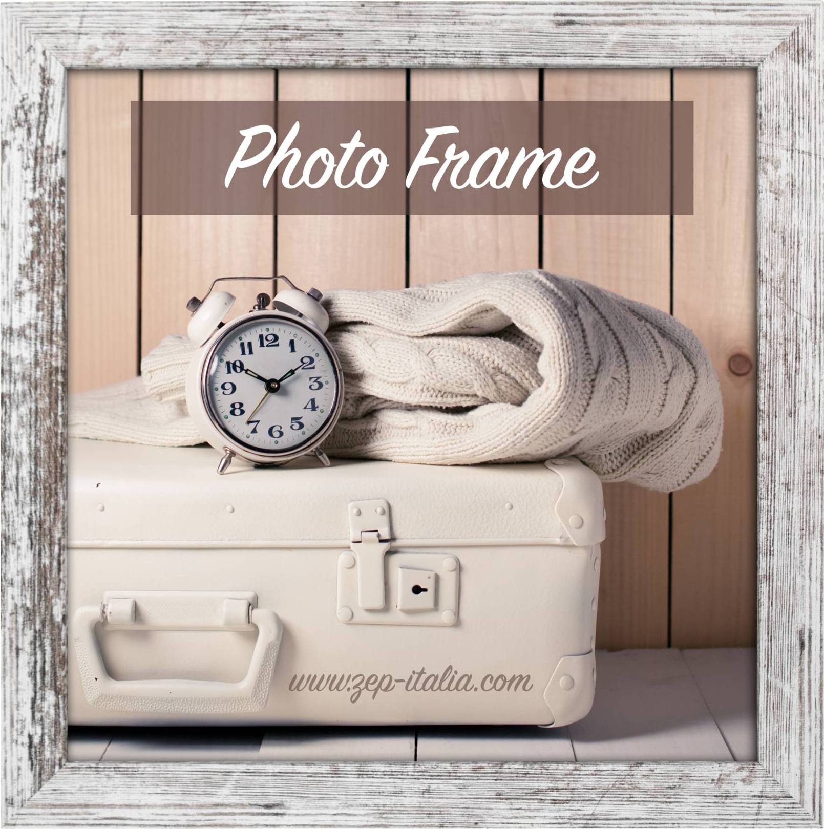 Ein weißer Koffer mit einem beigen Strickschal und einem Wecker darauf. Im Hintergrund steht 'Photo Frame'.