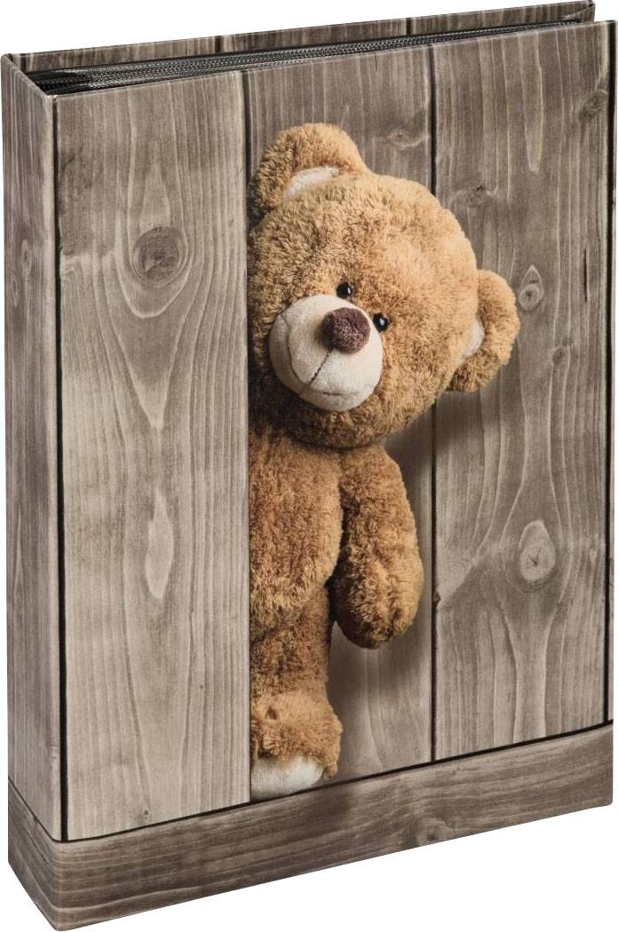 Ein Plüschteddy schaut aus einer Holzkiste hervor, als ob er verstecken spielt. Der Hintergrund hat eine Holzmaserung.