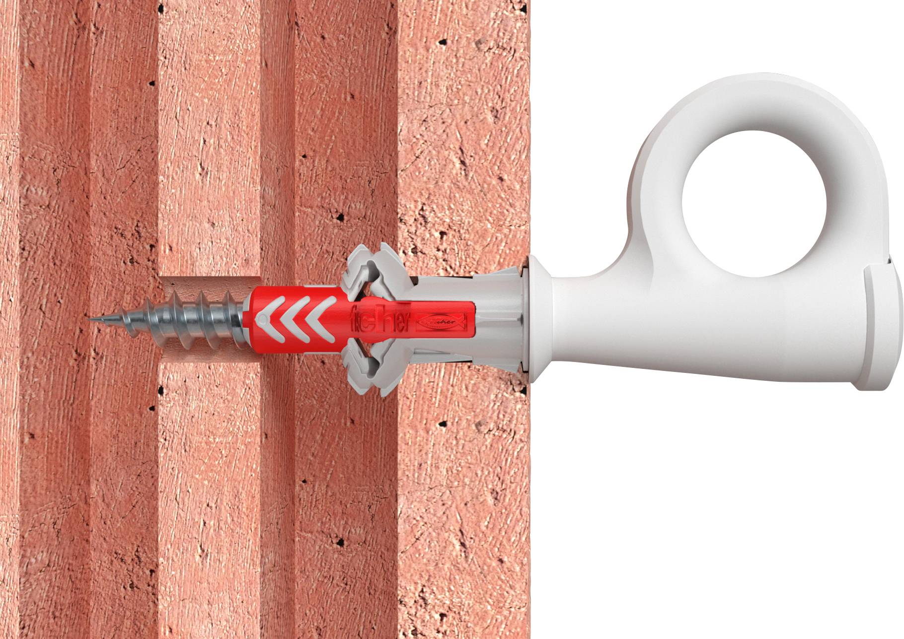 Ein Dübel wird in eine Ziegelwand geschraubt. Der Dübel ist rot und weiß mit einer Schraube in der Mitte.