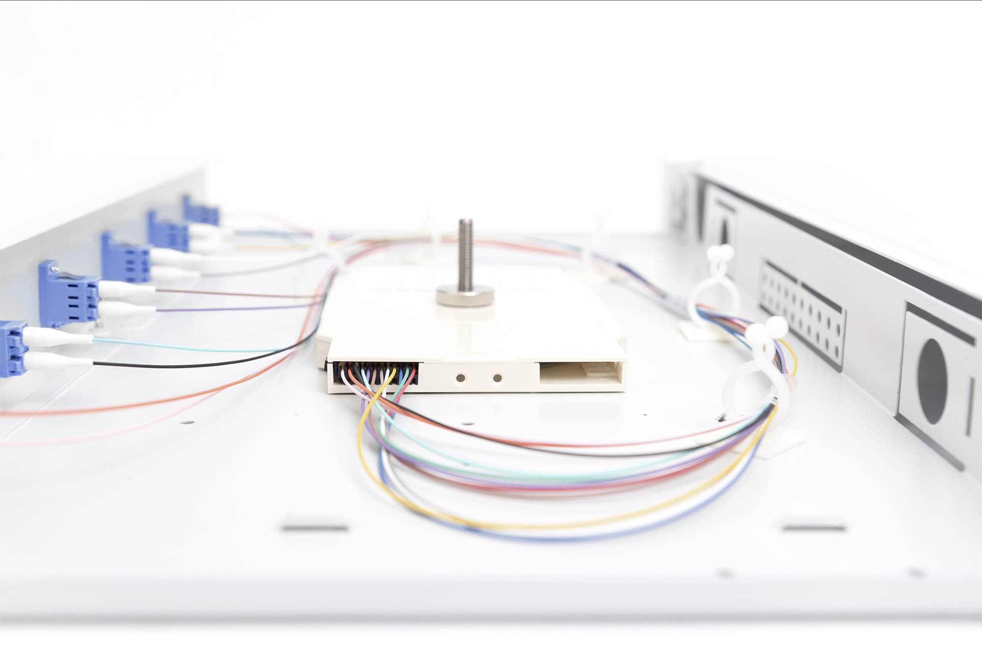 Elektronisches Gerät zeigt farbige Kabel, die mit Steckern verbunden sind, in einer technischen Installation.