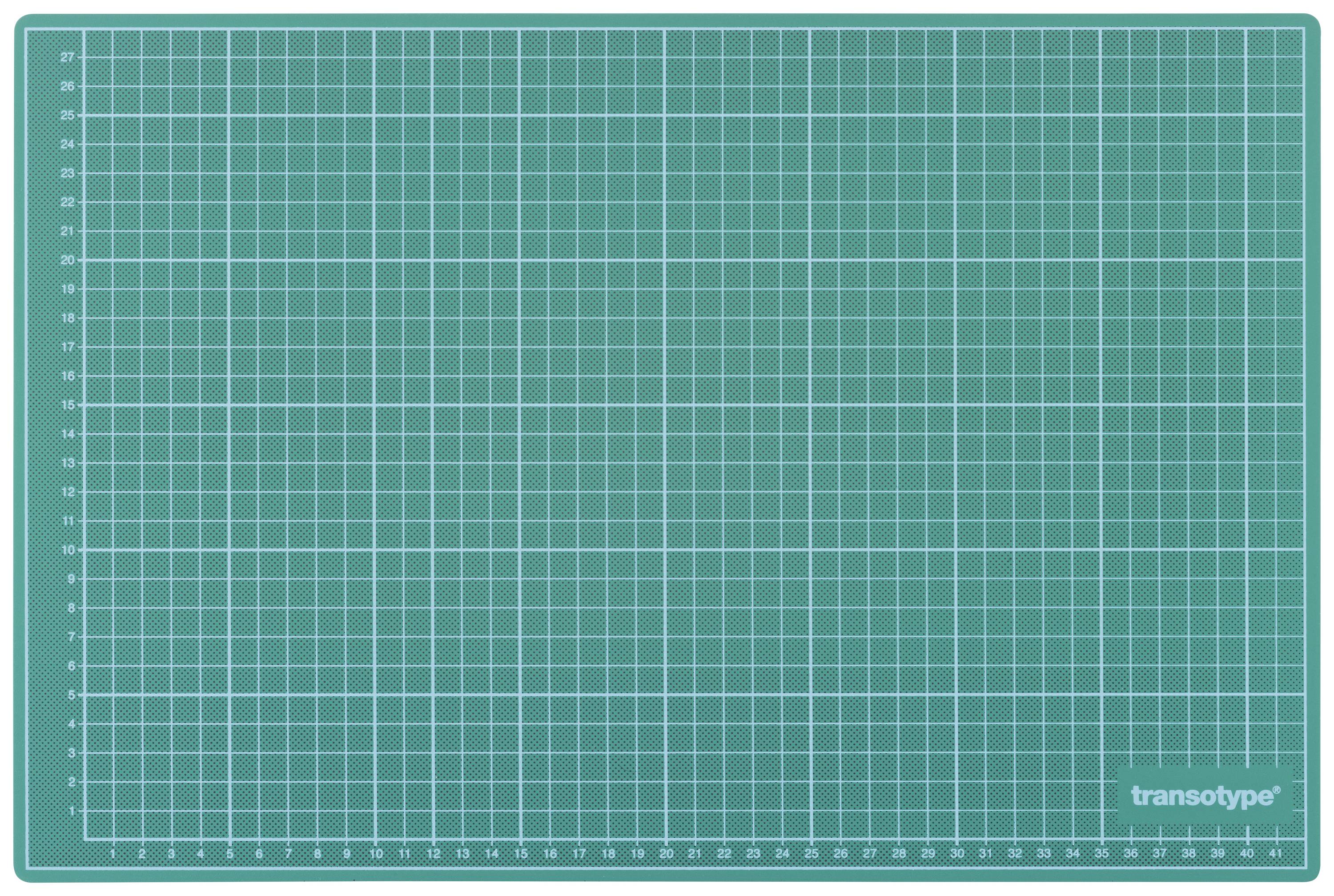 Grüne Schneidematte mit weißen Rasterlinien und Maßeinheiten an den Rändern.