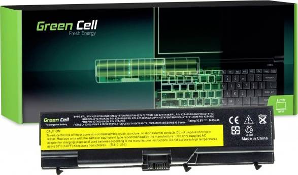 Laptop-Akku und Verpackung mit der Aufschrift 'Green Cell Fresh Energy'. Hinweise zur Nutzung und Sicherheitswarnungen auf gelbem Etikett.