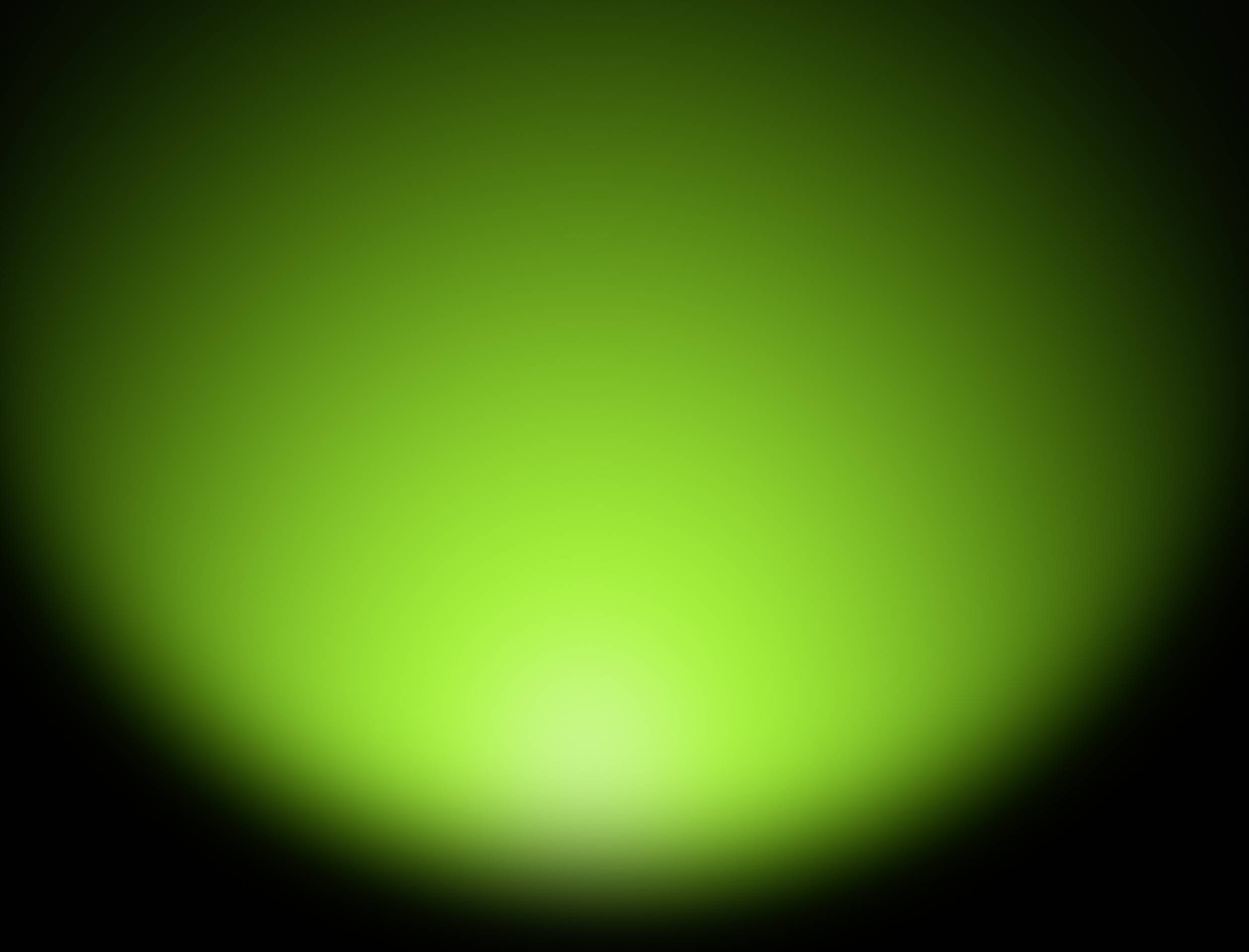 Ein leuchtendes, grünes Licht strahlt von der Mitte einer schwarzen Fläche aus.