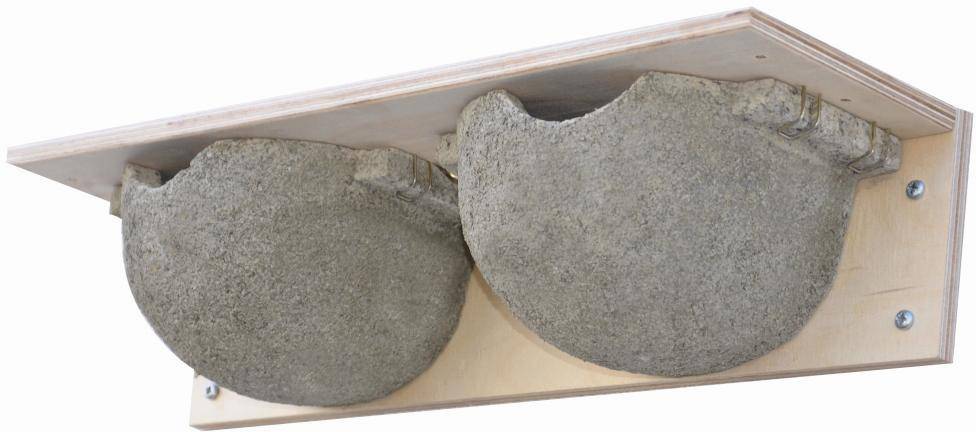 Zwei künstliche Mehlschwalbennester aus Beton auf einer Holzplatte montiert, zur Unterstützung von Schwalben beim Nestbau.