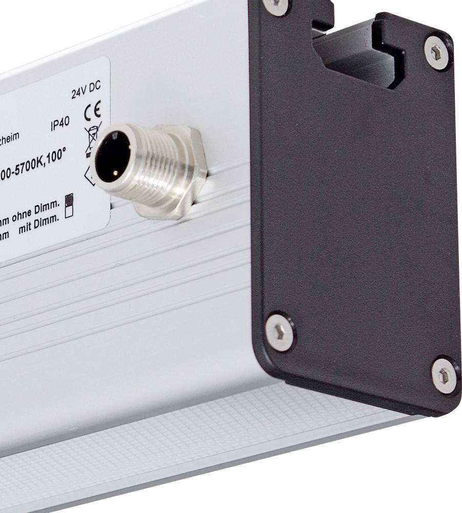 Ein rechteckiges elektrisches Gerät mit Metallgehäuse und Anschlussstecker. Ein kleiner Abschnitt eines Etiketts mit technischer Information ist sichtbar.