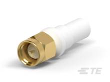 Ein weißer, zylindrischer Adapter mit einem goldenen Sechskantanschluss, möglicherweise für Kabelverbindungen.
