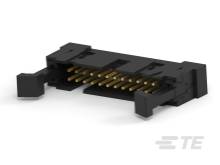 Ein schwarzer elektrischer Stecker mit goldenen Kontakten auf einer weißen Fläche, schräg von oben fotografiert.