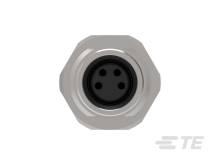 Ein grauer, sechseckiger Metallstecker mit vier schwarzen Kontaktpunkten in der Mitte. Kein zusätzlicher Kontext gegeben.