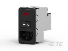 Schwarzer Kippschalter mit einem roten Indikator auf einem rechteckigen Gehäuse, das auf einer grauen Oberfläche steht.