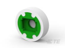 Ein Kunststoffteil mit grünem Innenbereich und kreisförmiger Form, vermutlich ein technisches Bauteil oder Adapter.