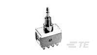 Ein rechteckiger elektronischer Bauteil mit fünf Stiften und einem zylinderförmigen Aufsatz. Möglicherweise ein Schalter oder Potentiometer.