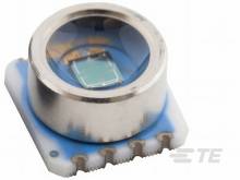 Ein runder, metallischer Sensor mit einem sichtbaren Chip in der Mitte, montiert auf einem kleinen blauen Schaltkreis.