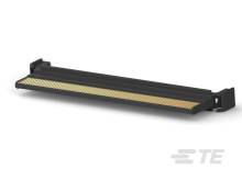 Schwarzes, längliches technisches Gerät mit gelblicher Oberfläche, möglicherweise ein Kühlkörper oder Verbindungselement, auf grauem Hintergrund.