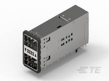 Ein graues elektrisches Steckermodul mit mehreren Anschlüssen und grünen Indikatoren auf der Seite.