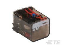 Eine transparente Plastikbox zeigt elektronische Komponenten und rote Kabel. Sie scheint Teil eines technischen Geräts zu sein.