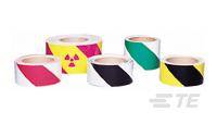 Verschiedene Klebebandrollen mit Warnmuster: gelb-rot mit Strahlensymbol, schwarz-weiß und grün-weiß. Verwendet zur Gefahrenkennzeichnung.