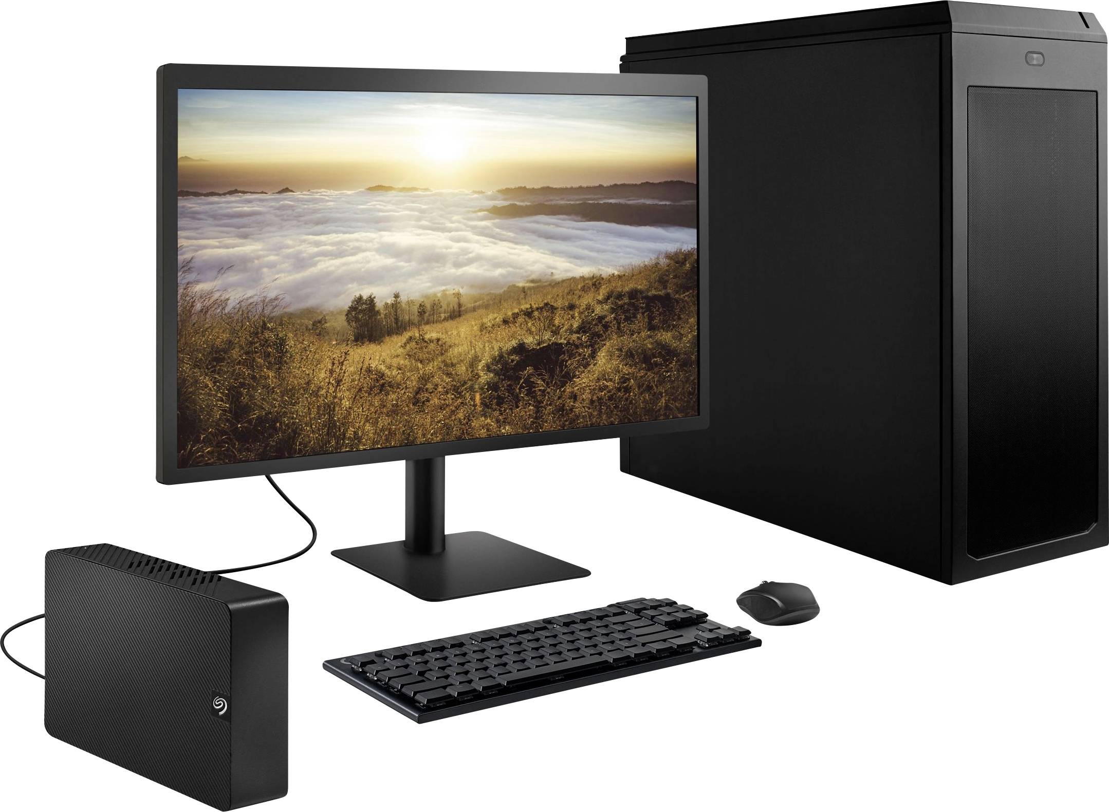 Ein Desktop-PC mit Monitor, Maus und externer Festplatte. Auf dem Bildschirm ist eine Landschaft mit Sonnenaufgang über Wolken zu sehen.