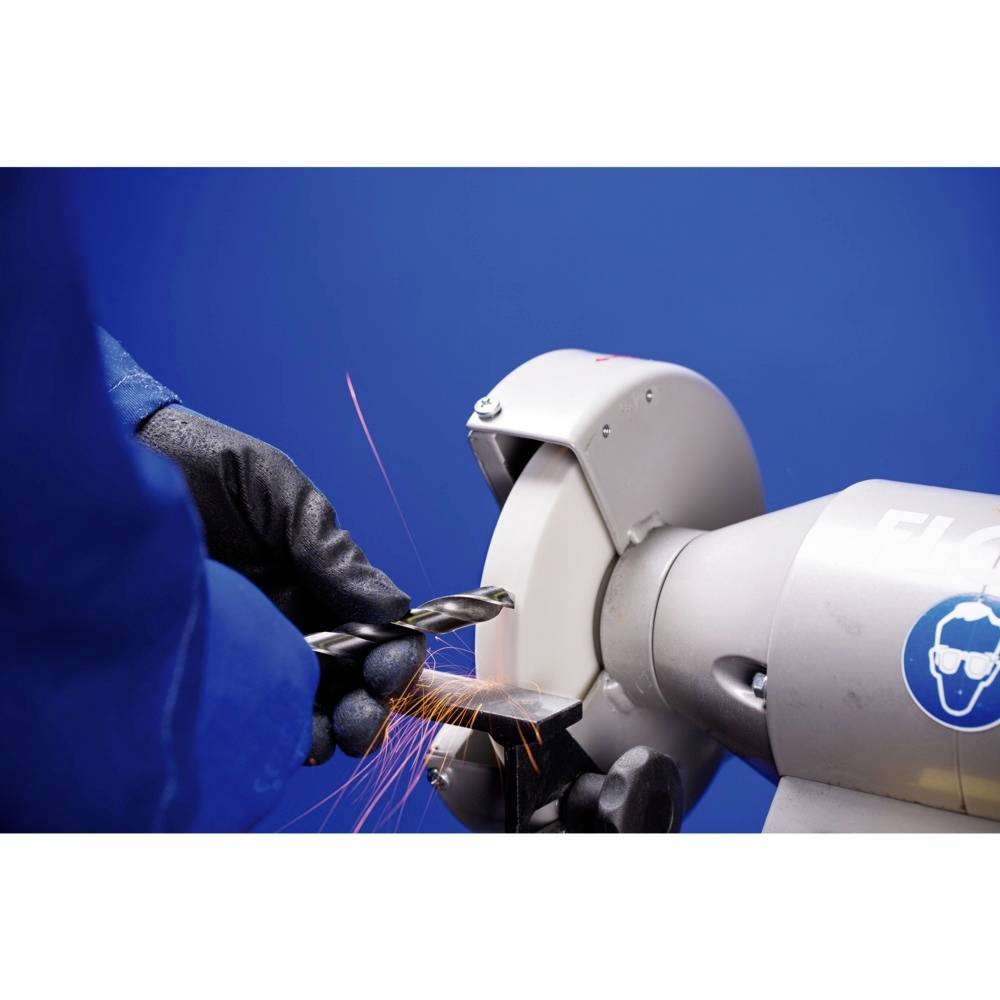 Nahaufnahme eines Bohrschleifgeräts mit Funkenflug, benutzt von einer Person in blauer Schutzkleidung gegen blauen Hintergrund.