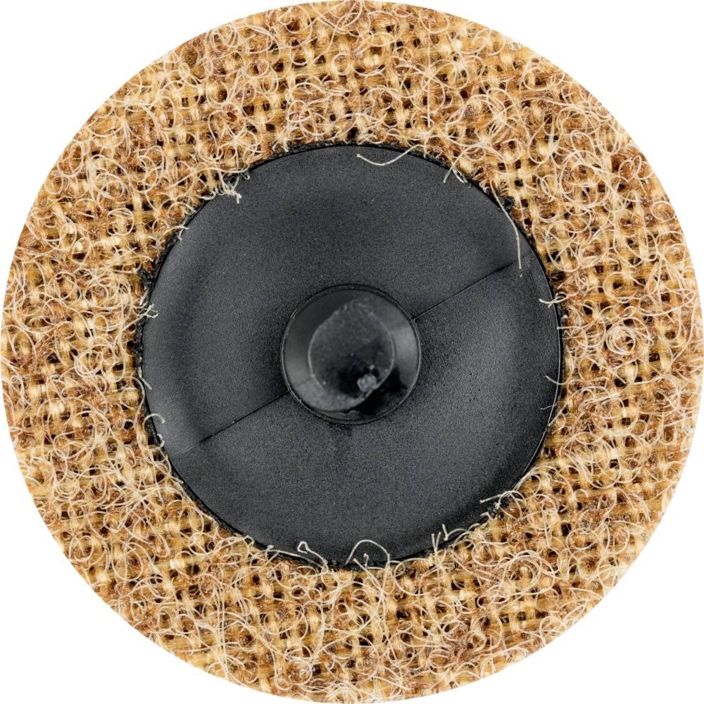 Nahaufnahme eines runden Klettpads mit braunem, flauschigem Rand und schwarzem Kunststoffzentrum.