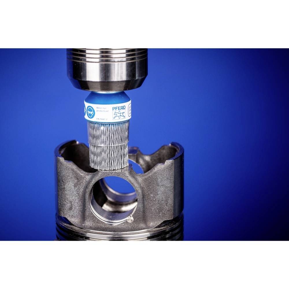 Schleifwerkzeug bearbeitet eine Metalloberfläche. Ein Zylinderförmiger Fräser scheint eine runde Öffnung zu glätten.