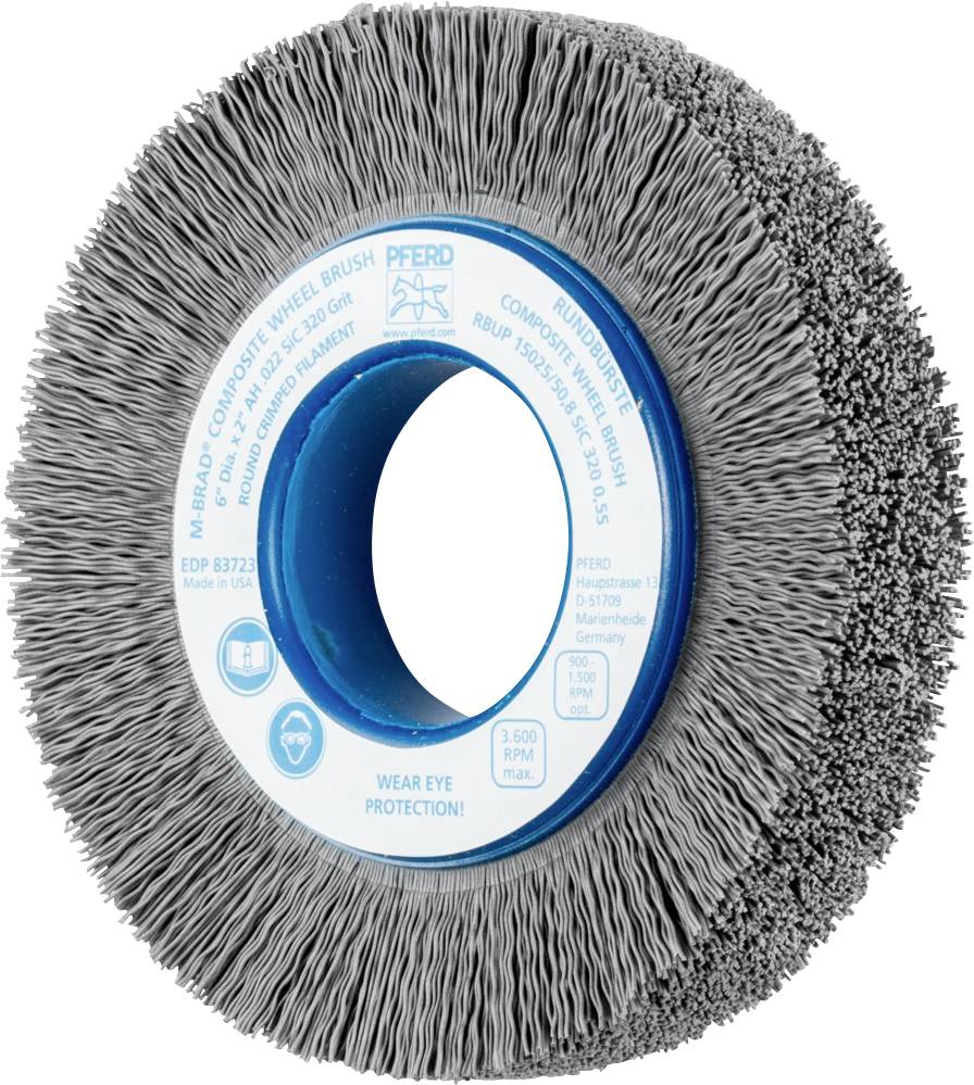 Runde Bürste mit dichtem Borstenkranz. Blaue Mitte mit Beschriftung 'Wear eye protection!'. Geeignet für industrielle Anwendungen.